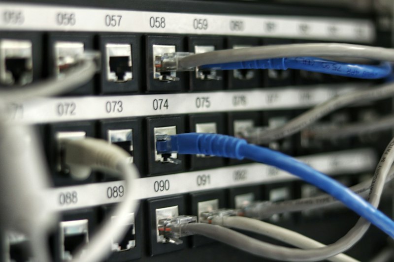 Network engineer configuring enterprise switching and fiber optic connectivity